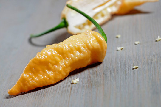 naga jolokia yellow on wooden background