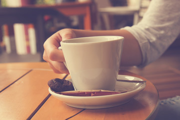 Urban girl drinking a coffee outdoors.