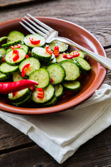 Fresh salad of cucumbers with red hot chili pepper