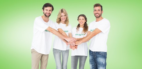 Happy volunteers with hands together