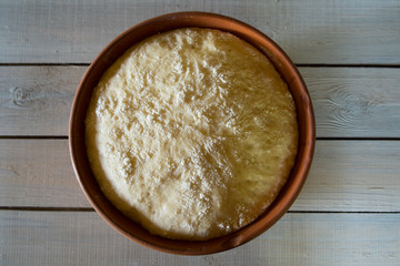 dough in a brown bowl