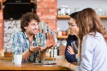 Friends meeting in cafe and drinking coffee