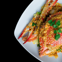 Stirred Fried Crab with Curry Powder on black background