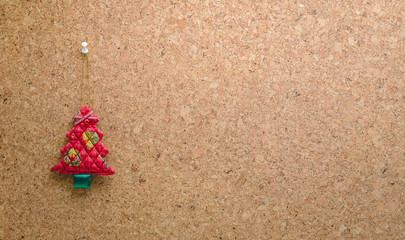 Cork message board with hanging red christmas tree