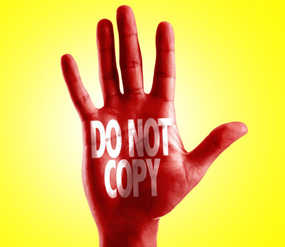 Do Not Copy written on hand with yellow background