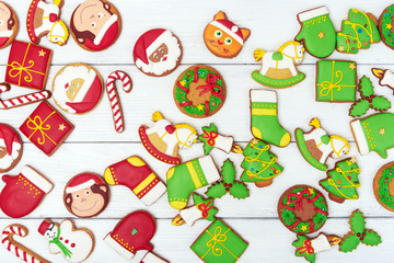 Christmas green and red gingerbread cookies on wooden background