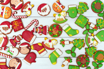 Christmas green and red gingerbread cookies on wooden background