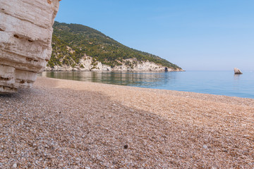 Sandy beach with blue sea and mountains