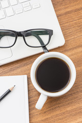 Coffee cup and laptop at office