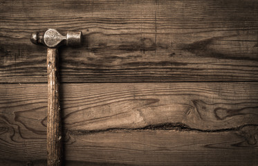 Old retro hammer on wooden workbench - 97117355
