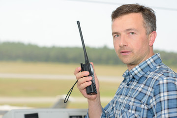 Man holding radio receiver