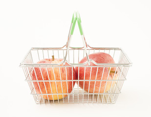 Shopping basket with red apples