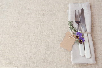 Table place setting with rosemary and empty tag, copy space background