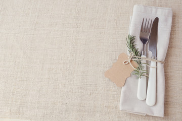 Table place setting with rosemary and empty tag, copy space background