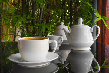 Close up cup of Coffee, latte on the black glass table