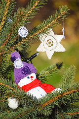 Snow man figurine in the christmas tree