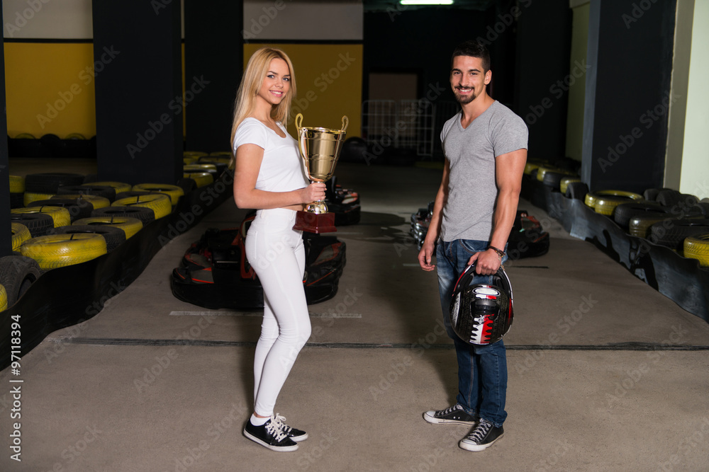 Wall mural Woman Gives Man A Cup Speed Karting Race