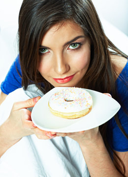 Young woman hold plate with donut.