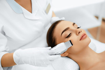 Skin Care. Close-up Of Beautiful Woman Receiving Ultrasound Cavitation Facial Peeling. Ultrasonic Skin Cleansing Procedure. Beauty Treatment. Cosmetology. Beauty Spa Salon.