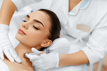 Face Skin Care. Closeup Of Beautiful Woman Getting Diamond Microdermabrasion Peeling Treatment In A...