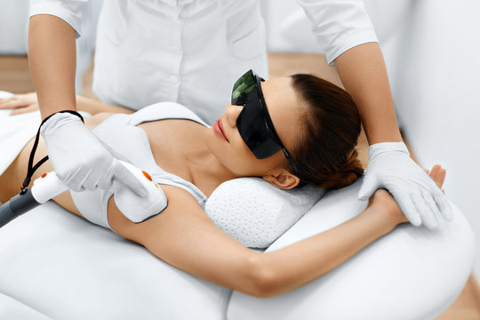 Body Care. Underarm Laser Hair Removal. Beautician Removing Hair Of Young Woman's Armpit. Laser Epilation Treatment In Cosmetic Beauty Clinic. Hairless Smooth And Soft Skin. Health And Beauty Concept.