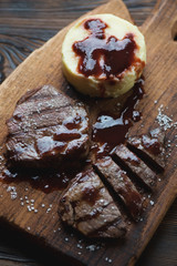 Close-up of grilled beefsteaks with potato puree and sauce
