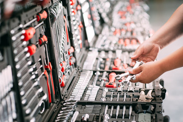 Worker at the store chooses wrench tools