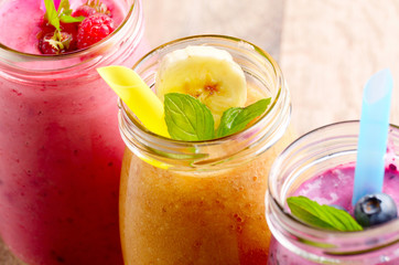 Assorted fruit shakes on white table