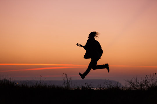 Man jumping with guitar