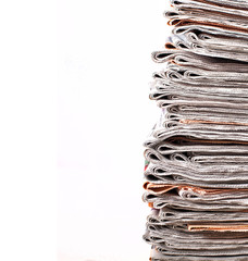 stack of daily newspapers isolated on white background. news, information, media
