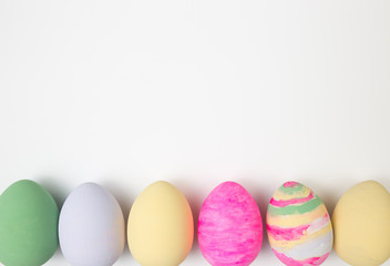 Fototapeta na wymiar Easter eggs painted in pastel colors on a white background