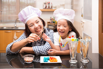 Mother and daughter making jelly ball