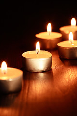 Fototapeta na wymiar Candles On Wood