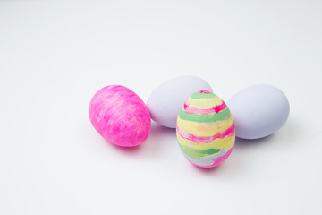 Easter eggs painted in pastel colors on a white background