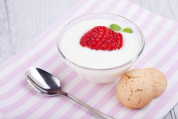 yogurt and strawberries on romantic background