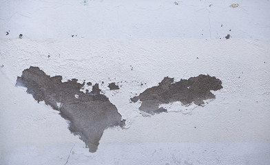 Old white paint on grey cement wall