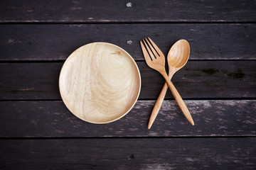 Wooden plate set on dark wooden floor