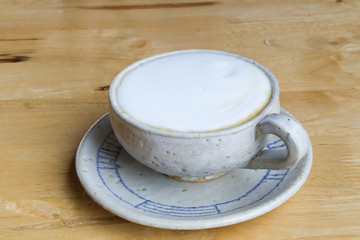 Close up Vintage cup of Coffee, latte on wooden background