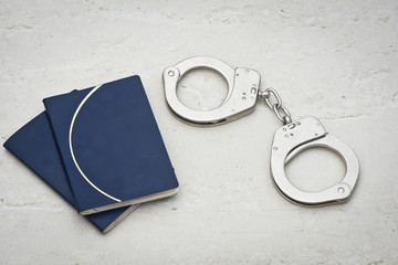 passport with handcuffs - prison concept