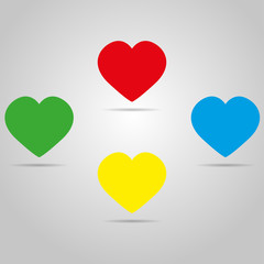 Four colored hearts with shadow on a grey color
