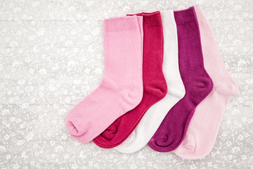 Pink, White and Purple Pair of Child Socks on White Background