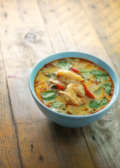 tom yum kung on rustic wood
