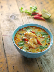 tom yum kung on rustic wood