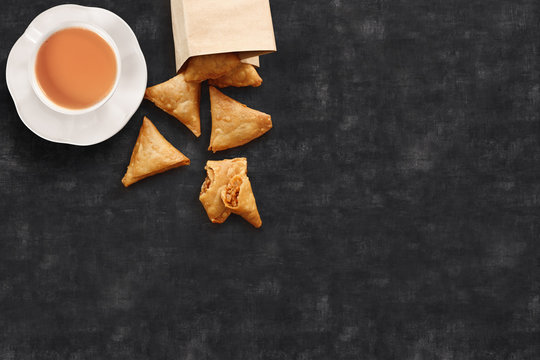 Tea/chai served along with crisp samosas, a local snack