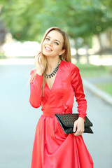 Beautiful young girl posing on city street