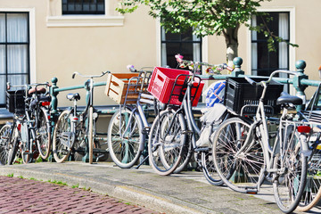 Parked bicycles on a railing in the historic canal belt, Amsterdam, The Netherlands