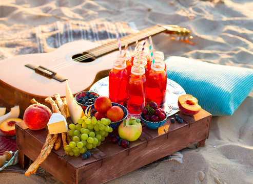 Picnic on the beach at sunset in the boho style