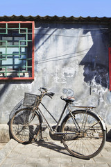 Old rusty bicycle parked in a hutong, Beijing, China.