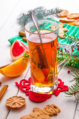 Winter hot drink with spices on wooden table.