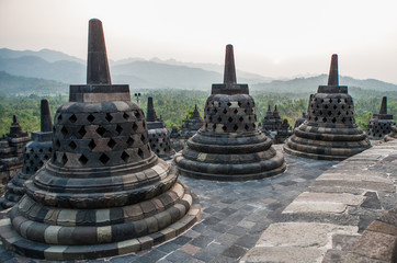 Stone stupa on the background of the surrounding landscape. Borobudur. Indonesia. The island of Java. An excellent illustration.